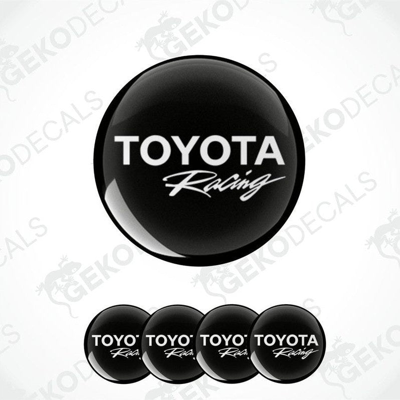 A set of four black vinyl stickers with the TOYOTA RACING logo, designed for use on car wheels or caps.