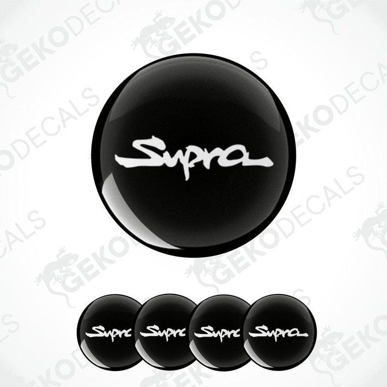 A set of four black vinyl stickers with the word 'TOYOTA SUPRA' written on them, designed for use as car decals.
