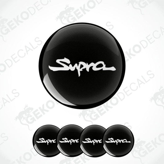 A set of four black vinyl stickers with the word 'TOYOTA SUPRA' written on them, designed for use as car decals.