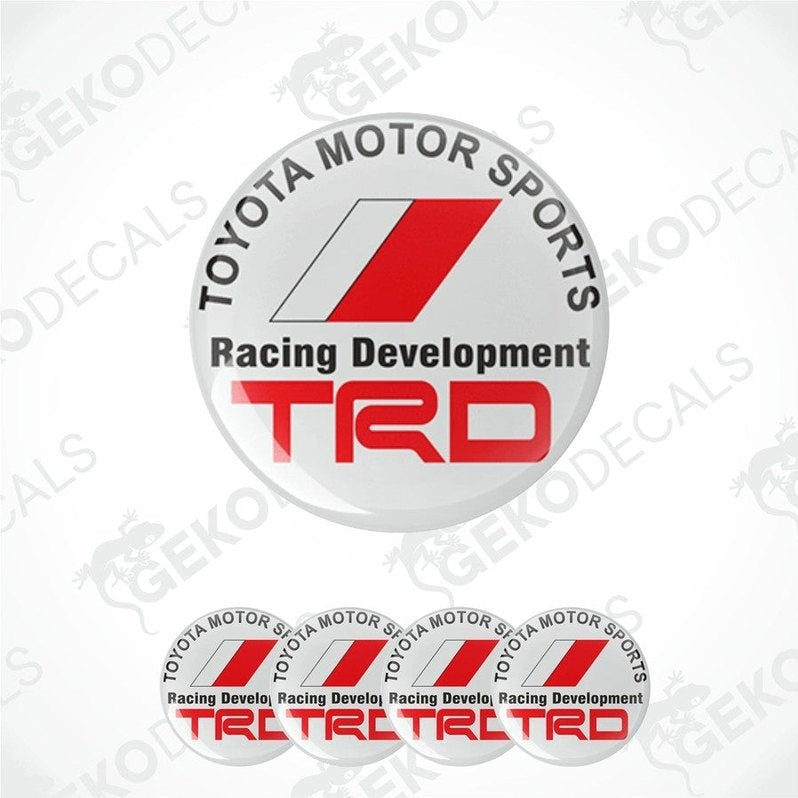 A set of four white vinyl stickers with red and gray Toyota Racing Development (TRD) branding, designed for use on vehicle wheels or caps.