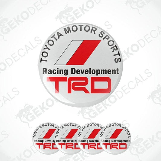A set of four white vinyl stickers with red and gray Toyota Racing Development (TRD) branding, designed for use on vehicle wheels or caps.