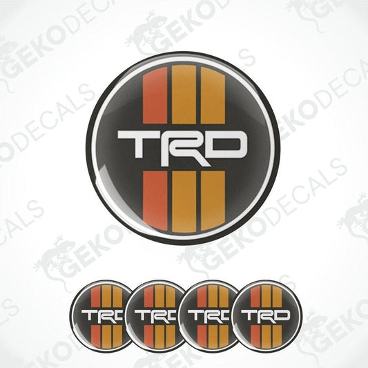 A set of four black, red, and white vinyl stickers with the letters 'TRD' in the center.