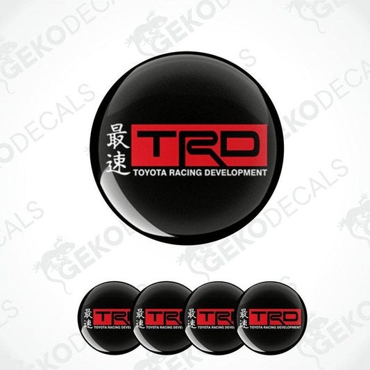 A set of black round car decals with the Toyota Racing Development (TRD) logo in red and white.