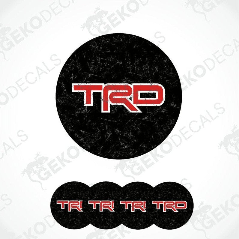 A set of four black vinyl decals with red 'TRD' logo, designed for use as car wheel stickers.