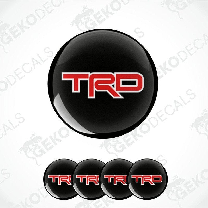A set of four black vinyl decals with red 'TRD' logo, designed for use as car wheel stickers.