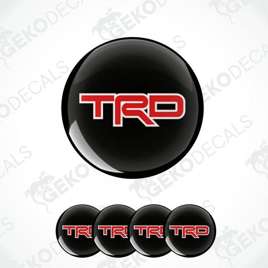 A set of four black vinyl decals with red 'TRD' logo, designed for use as car wheel stickers.
