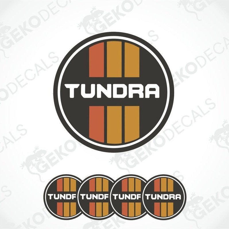A set of four orange, black, and white vinyl stickers with the word 'TUNDRA' printed on them.