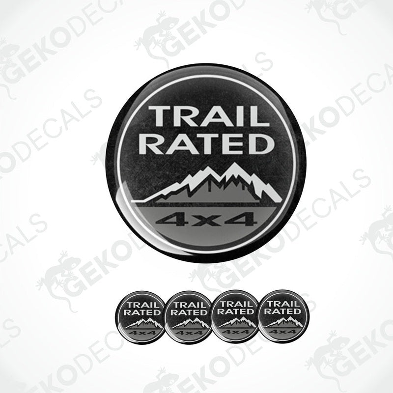 A set of black vinyl decals with 'TRAIL RATED 4x4' text and mountain graphics, designed for use as car stickers.