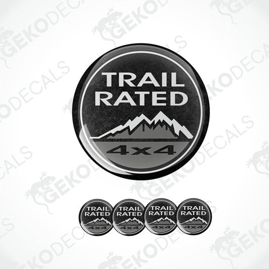 A set of black vinyl decals with 'TRAIL RATED 4x4' text and mountain graphics, designed for use as car stickers.