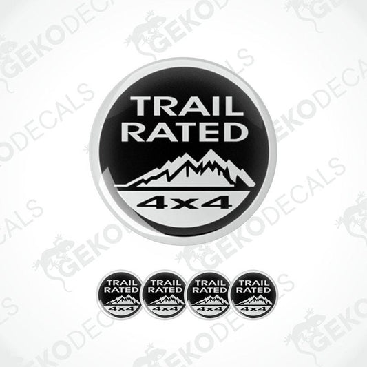 A set of four black and white vinyl stickers with the text 'TRAIL RATED 4X4' and a mountain range design.