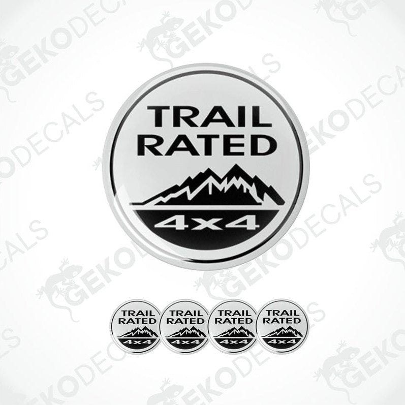 A set of four white and black vinyl stickers with the text 'TRAIL RATED 4X4' and a mountain range design.