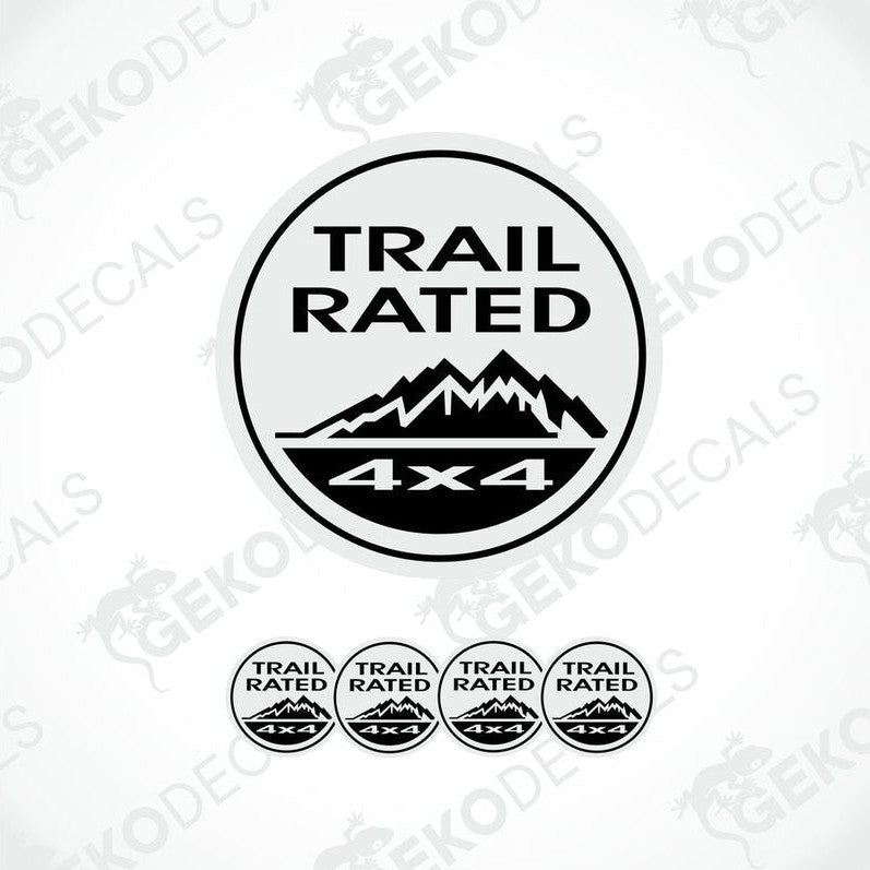 A set of four white and black vinyl stickers with the text 'TRAIL RATED 4X4' and a mountain range design.
