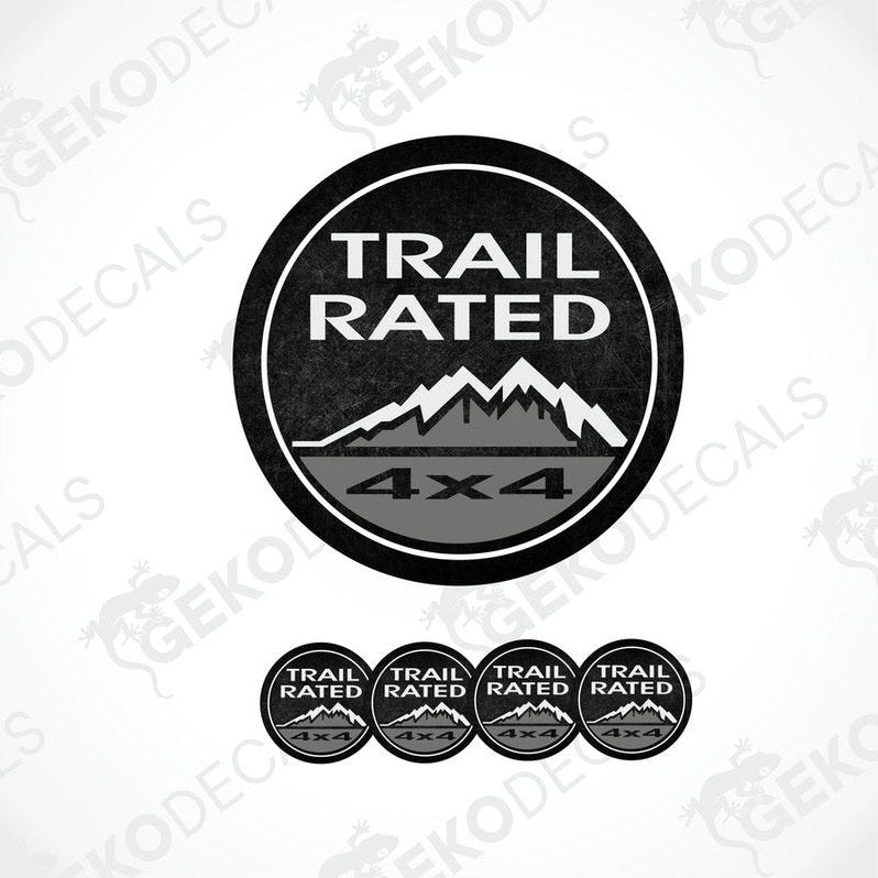 A set of black vinyl decals with 'TRAIL RATED 4x4' text and mountain graphics, designed for use as car stickers.