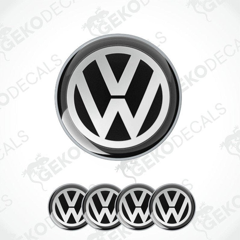 A set of four black and white dome-shaped vinyl decals with the Volkswagen logo.