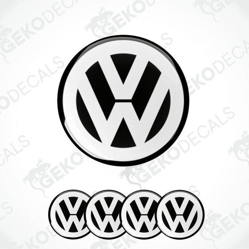 A set of black and white vinyl decals for a Volkswagen vehicle, including one large emblem and three smaller dome stickers.