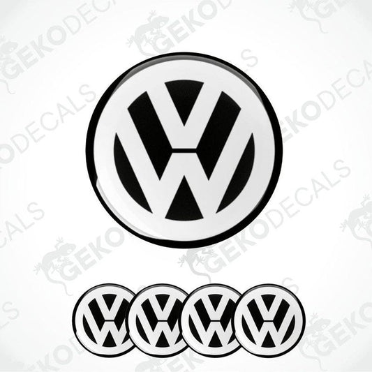 A set of black and white vinyl decals for a Volkswagen vehicle, including one large emblem and three smaller dome stickers.