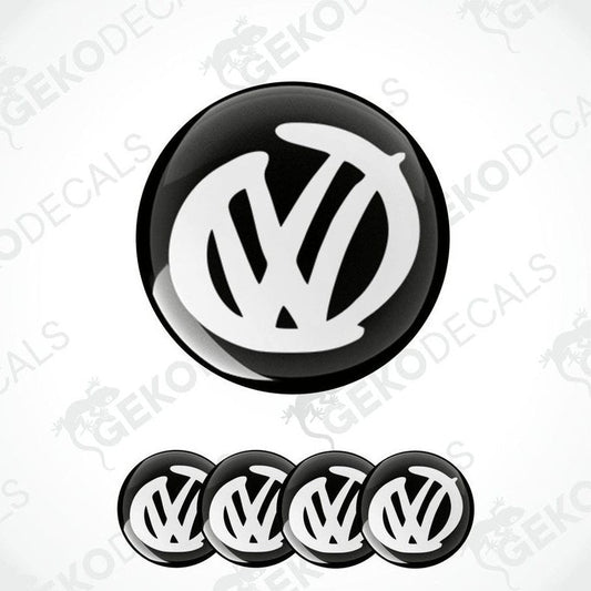 A set of four black and white volkswagen emblem stickers with a dome shape, displayed against a white background.