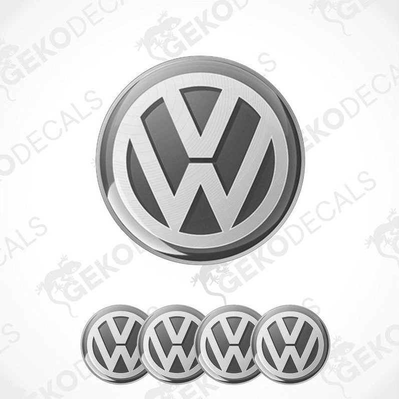 A set of four silver volkswagen emblem stickers with a dome shape, designed for use on car wheels or caps.