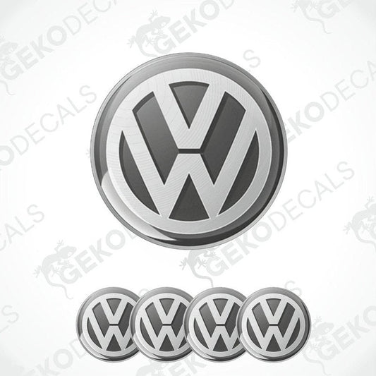 A set of four silver volkswagen emblem stickers with a dome shape, designed for use on car wheels or caps.