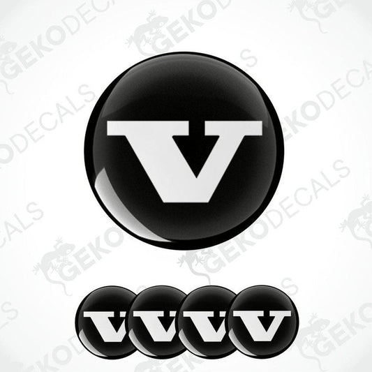 A set of four black vinyl stickers with a bold letter 'VOLVO' in the center, arranged on a white background. The stickers have a glossy finish.