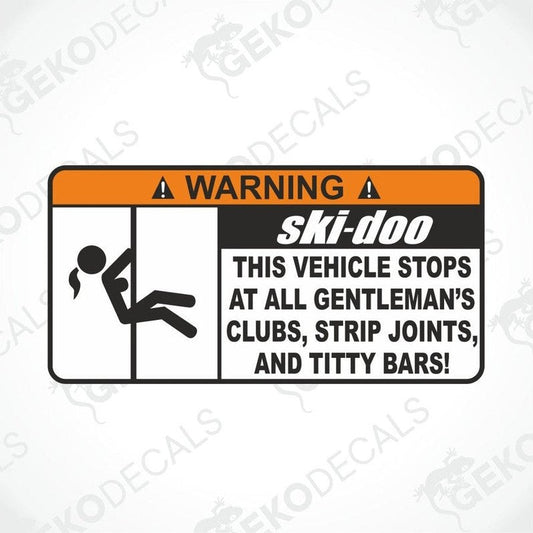 A black and orange vehicle decal with the text 'WARNING' and a graphic of a person performing a stunt on a vehicle.